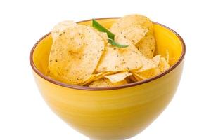 Potato chips in a bowl on white background photo