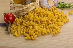 Fusilli on wooden background photo