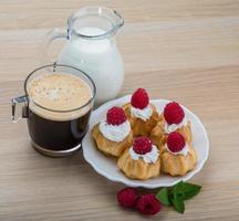 Profiterole with raspberry photo