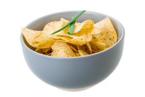 Potato chips in a bowl on white background photo