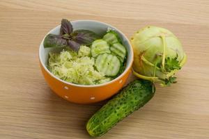 Kohlrabi salad on wooden background photo