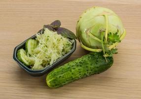 Kohlrabi salad on wooden background photo