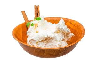 Cottage cheese in a bowl on white background photo