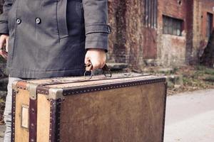 Unrecognizable man carrying a suitcase. photo