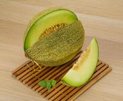 Melon on wooden background photo