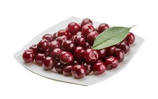 Cherry in the bowl on white background photo