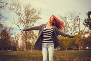 mujer despreocupada disfrutando de su libertad con los brazos extendidos. foto