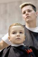 Below view of boy at hairdresser's. photo