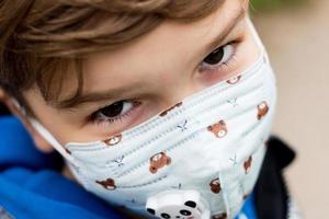 Close-up of boy with protective face mask. photo