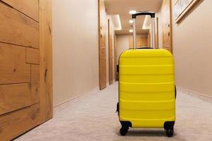 Yellow travel bag in a hallway. photo