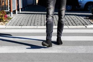 Unrecognizable man crossing the street. photo