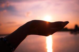Sunset in a hand. photo