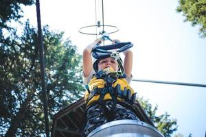 Directly below view of boy on rope course in nature. photo