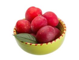 Damson plum in a bowl on white background photo