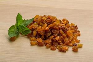 Raisin on wooden background photo