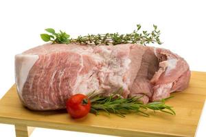 Raw pork meat on wooden plate and white background photo