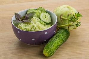 Kohlrabi salad on wooden background photo