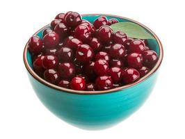 Cherry in the bowl on white background photo