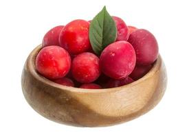 Damson plum in a bowl on white background photo