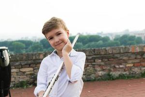 Portrait of cute little flautist. photo