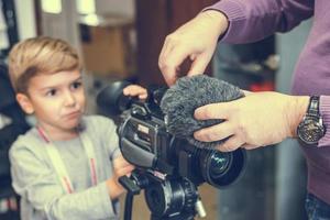 Close up of cameraman adjusting microphone on video camera. photo