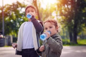 Kids drinking water in the park. photo