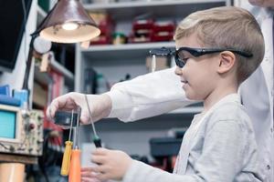 Physics experiment with magnet and work tools. photo