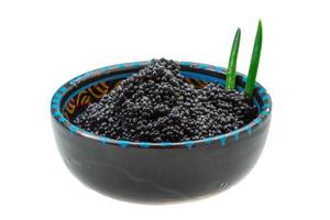 Black caviar in a bowl on white background photo