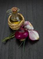 Oil, vinegar with rosemary on wooden background photo
