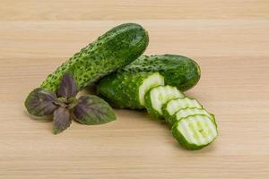 Cucumber on wooden background photo