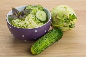 Kohlrabi salad on wooden background photo