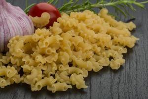 Fusilli on wooden background photo