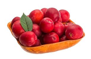 Damson plum in a bowl on white background photo