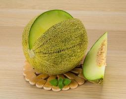 Melon on wooden background photo