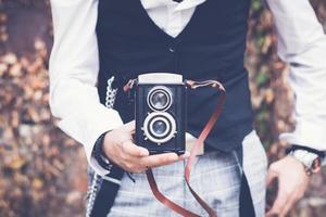 Close up of man with with vintage medium format photo camera.