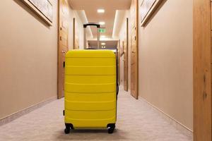 Yellow suitcase in a lobby. photo