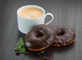 Chocolate donuts on wooden background photo