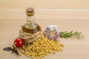 Shell pasta on wooden background photo