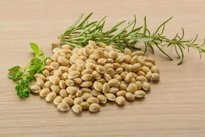 Raw soya bean on wooden background photo