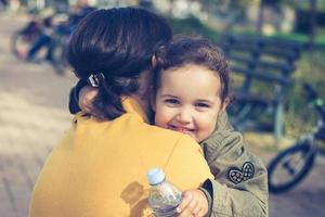 Happy daughter embracing her mother. photo