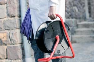 Unrecognizable maintenance worker with power plug reel. photo