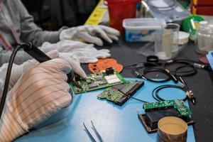 Close up of soldering microchip on circuit board. photo