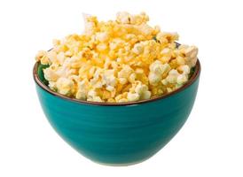 Popcorn in a bowl on white background photo