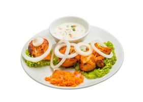 Chicken Tikka on the plate and white background photo