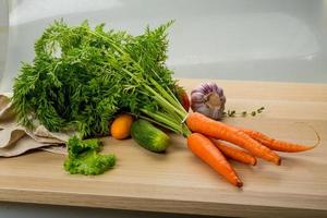 Carrrot on wooden plate photo