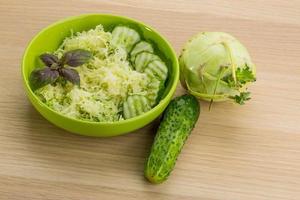 Kohlrabi salad on wooden background photo