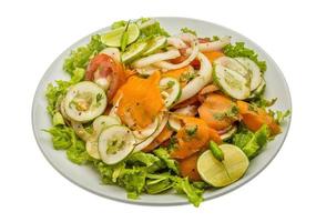 Cucumber salad on the plate and white background photo