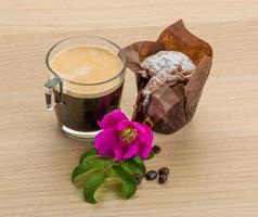 Muffin with coffee on wooden background photo