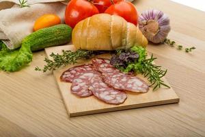 Salami on wooden plate photo