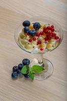 Jelly with berry on wooden background photo